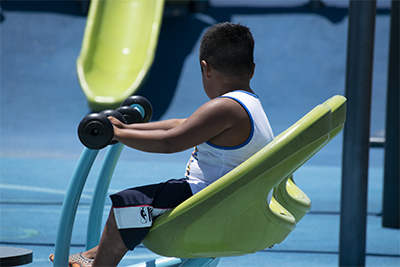 Child seated on merry-go-round at Salinas Park.