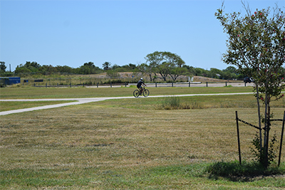 View of park grounds and biker in the distance.